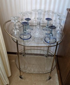 lot 81 image: Oval Serving Cart on Wheels with Glass Shelves and Drinking Glasses