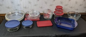 lot 63 image: Miscellaneous Glass Kitchen Ware Pyrex and Anchor Storage Containers with Lids, Measuring Cups, Pans, and More