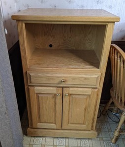 lot 68 image: Single Drawer Microwave Stand on Wheels with Measuring Cups, Ladles, Ice Cream Scoops, Knifes and More