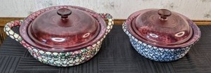 lot 56 image: Set of 2 Pink Vision Corning Casserole Dishes with Lids and Woven Hot Pads