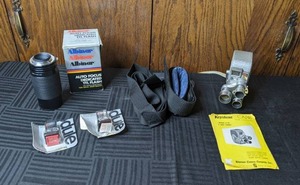lot 221 image: Vintage Keystone Capri 8mm Camera, Camera Lense, Auto Focus Dedicated TTL Flash, Camera Strap, 2 Dule Rechargable Batteries