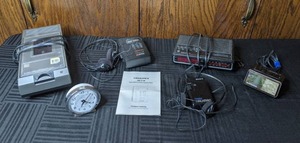 lot 213 image: Video Cassette Rewinder, Baby Ben Clock, Memorex Digital AMFM Stereo Cassette Player, Sony Walkman, GE Digital Clock Radio, Spartus Alarm Clock