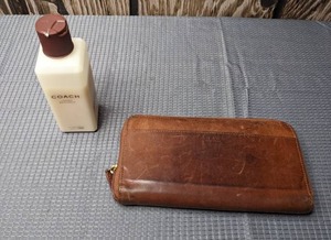 lot 388 image: Authentic Coach Wallet in Camel Colored Leather Plus a Bottle of Coach Leather Moisturizer