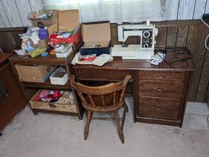 lot 360 image: 4-Drawer Crafting Desk, White Sewing Machine, 2-Shelf Stand, Spools of Thread, Yarn, Sewing Pins, Glue, Buttons, Padding and More