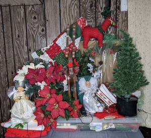 lot 313 image: Assortment of Christmas Holiday Decoration Decorative Bows, Angel Tree Topper, Light Up Poinsettias, Mini Countertop Tree, Pot Holders, Coasters, Table Cloths and More