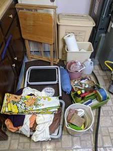 lot 308 image: Miscellaneous Assortment of T.V. Tray, Throw Rugs, Cleaning Supplies, Rags, Blue Plastic Bag Holder, Clothes Rack, Step Stool and More