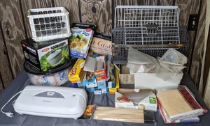 lot 298 image: Seal Meal Sealer, Good Grips Salad Spinner, Forever Bags, Food Saver Bags, Glad Cling Wrap, Plastic Wrap, Wax Paper, Aluminum Foil and More