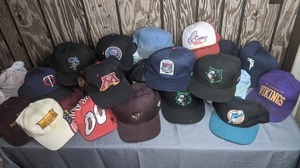 lot 411 image: Approximately 17 Baseball Style Caps  Hats MN Vikings, NFL, MLB, Twins, St. Paul Saints, Gophers, Timberwolves, NBA, Dolphins, and MORE