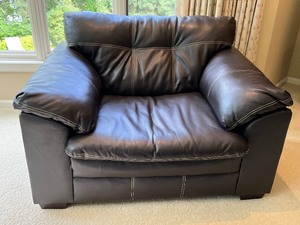 lot 9 image: Oversized Faux Leather Chair and Coordinating Storage Ottoman