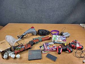 lot 96 image: Lot of Gaming Accessories, DVDs, Family Guy Collectibles and More