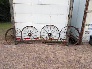 lot 19 image: Lot of (4) Antique Steel Wagon Wheels - Includes (2) 35 Diameter and (2) 31 Diameter - All are 4 Wide - NO SHIPPING