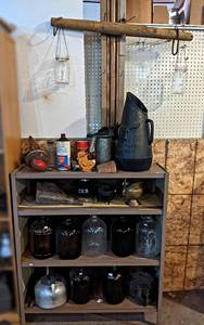lot 249 image: Shelf  Contents - Gallon Glass Jugs, Evener w Mason Jars, Oil Can, Galvanized Funnel and More - Metal Shelf is about 42 x 36 x 12 - NO SHIPPING