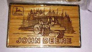 lot 86 image: (3) Wood and Metal John Deere Belt Buckles