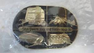 lot 90 image: John Deere Belt Buckle Factory Wrap, Hay and Forge Masters