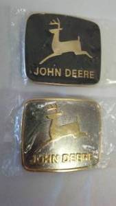 lot 244 image: John Deere Belt Buckle (2) Traditional Buck Logo.