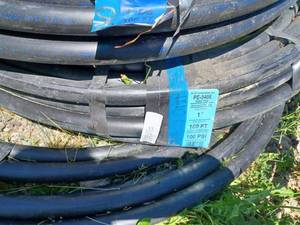 lot 127 image: Two 100-foot Rolls of New 1-inch Plastic Hose and Two Partial Rolls - 100 PSI