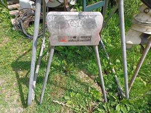 lot 348 image: Two Vintage Johnson Outboard Motor Stands, Large one is on caster and is 42-inches tall, the small stand is 33-inches tall
