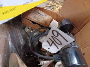 lot 409 image: Box of Assorted Marine Motor Parts Lower Unit Parts, 4-Cylinder Distributor Cap, New 10-foot 120 Volt Pump Switch with Plug, and More