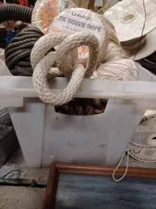 lot 411 image: 12-inch X 15-inch Plastic Tote Full of Assorted New Rope - Cotton and Nylon, 5 New Rolls of Tie-Down Rope 14-inch X 50-feet Sisal, and More