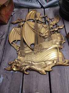 lot 413 image: Tall Gold Colored Plastic Plaque of an Old Sailing Ship 22-inches wide X 28.5-inches tall and a Small Plaque of a String Art Sailing Ship