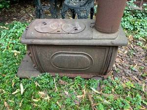 lot 36 image: Cast Iron Stove Lawn Ornament (On Site Pickup In Stillwater)