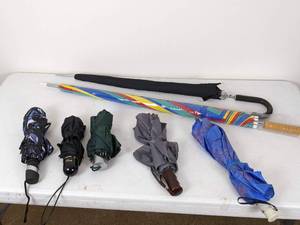 lot 107 image: A Collection of Seven Umbrellas in Various Sizes