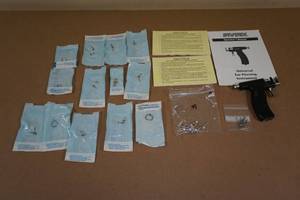 lot 213 image: Studex Piercing Gun with Sterile Earrings and Body Jewelry