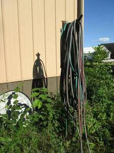 Big lot of water hoses hanging outs...