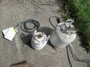 2 propane cylinders and a blow torc...