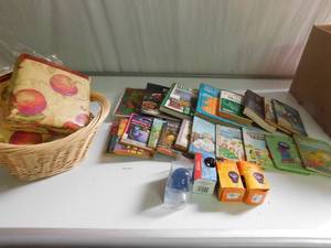Basket of 2 table clothes, colored light bulbs, hard & soft covered books