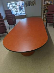 Large oval conference or banquet table that sits on round pedestals