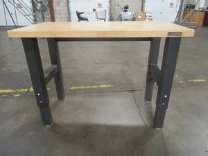 lot 260 image: Gladiator Work Bench, Approximate Dimensions 48 x 25 x (Height Adjustable, stands at 36 in photo). - Used in warehouse.