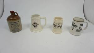 lot 50 image: Set of four advertising pottery mugs