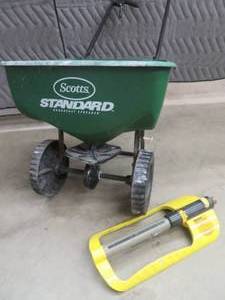lot 51 image: GRASS SPREADER  METAL SPRINKLER