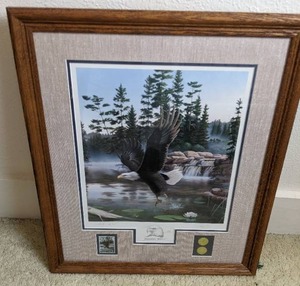 lot 86 image: 1990 Limited Edition Framed Matted Bald Eagle Print Boundary Waters by Leo Stans with National Park Series Coins and Stamp