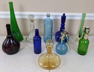 lot 73 image: Collection of 10 VintageModern Glass Bottles & Decanters  Jenny Lind Empire Glass Works, Skyy, Grolsch, & More