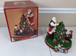 lot 40 image: Grandeur Noel Fabric Mache Santa Trimming the Tree Figurine and Biker Santa Ornament