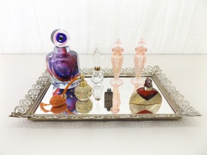 Collection of Vintage Perfume Bottles on Dresser Mirror