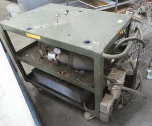 Not sure what this unit does but there is a hydraulic pump, cylinder and reservoir on the cart