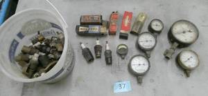 group of vintage New spark plugs and gauges