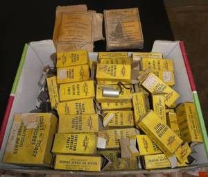 Box of vintage ignition and carb parts