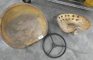 2 old tractor seats and steering wheel
