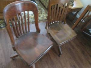 2 vintage wooden chairs on wheels...