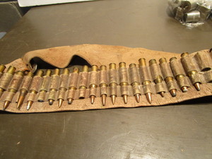 lot 179 image: Ammo belt with a variety of rounds...