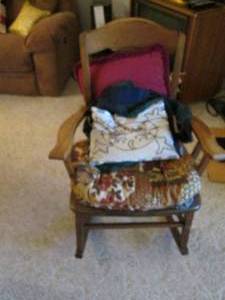 lot 102 image: Rocking chair w seat pad, pillows ...