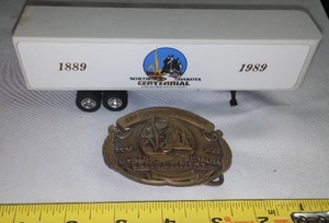 lot 272 image: N.D. Centennial Trailer & Belt Buckle