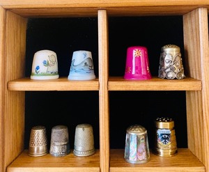lot 123 image: Wooden Shadow Box Shelf Full of a Variety of Thimbles