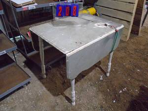 Drop leaf wood table. Could use a little glue on legs. As shown.