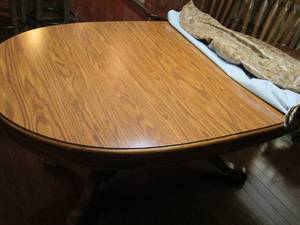 lot 123 image: Oak table with leaves stored inside...