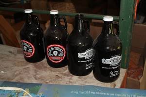 lot 151 image: Lot of (4) 64-fl.oz. Glass Beer Jugs